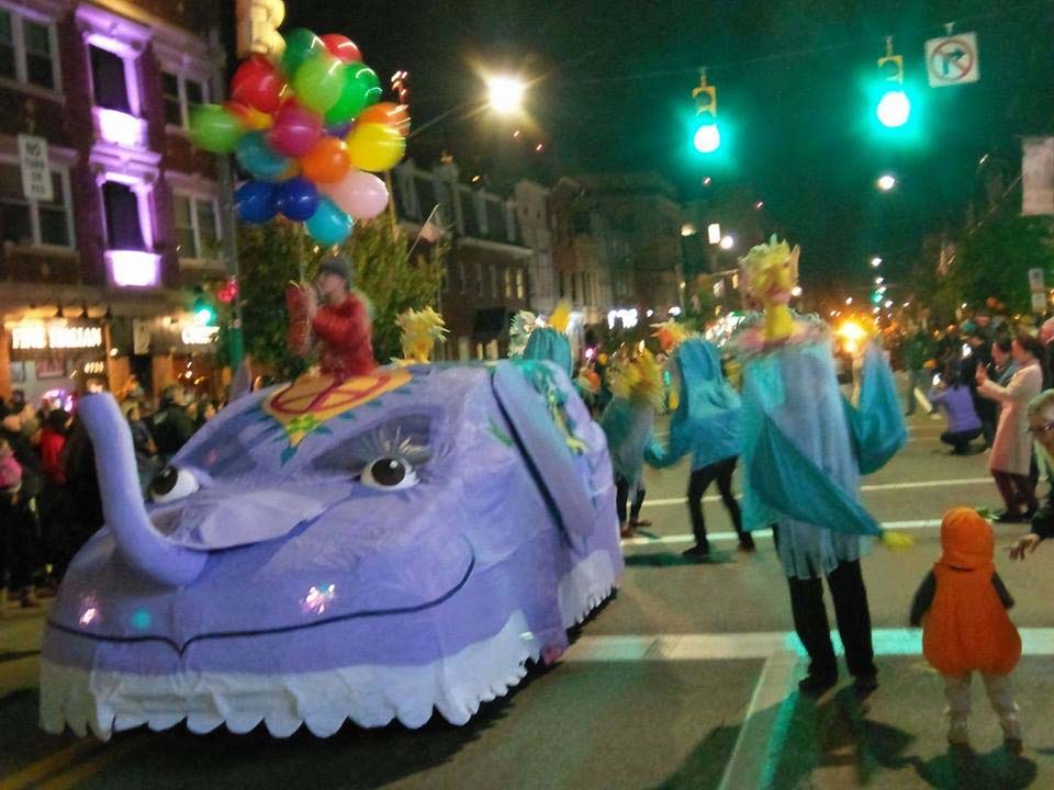 A car-moblie that looks like a purple elephant in a parade